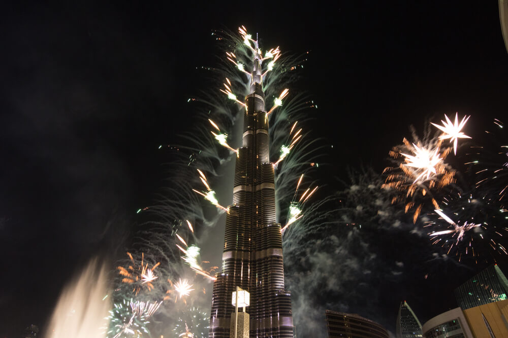 Burj Khalifa illuminated with fireworks during a celebration at night.