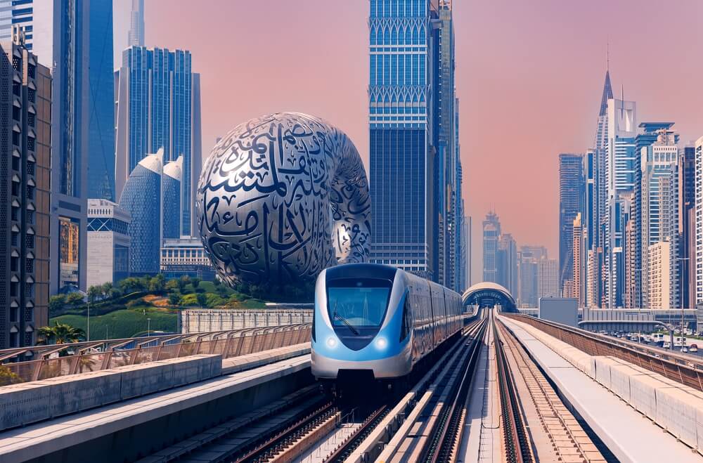 Dubai metro train passing near the Museum of the Future.