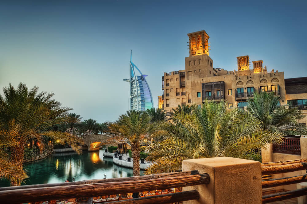 Traditional building with a view of the Burj Al Arab in the background.